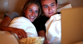 couple-watching-movie-in-bed