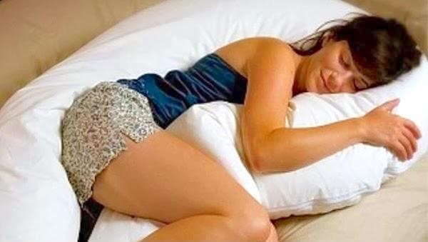 Sleeping-woman-hugging-pillow